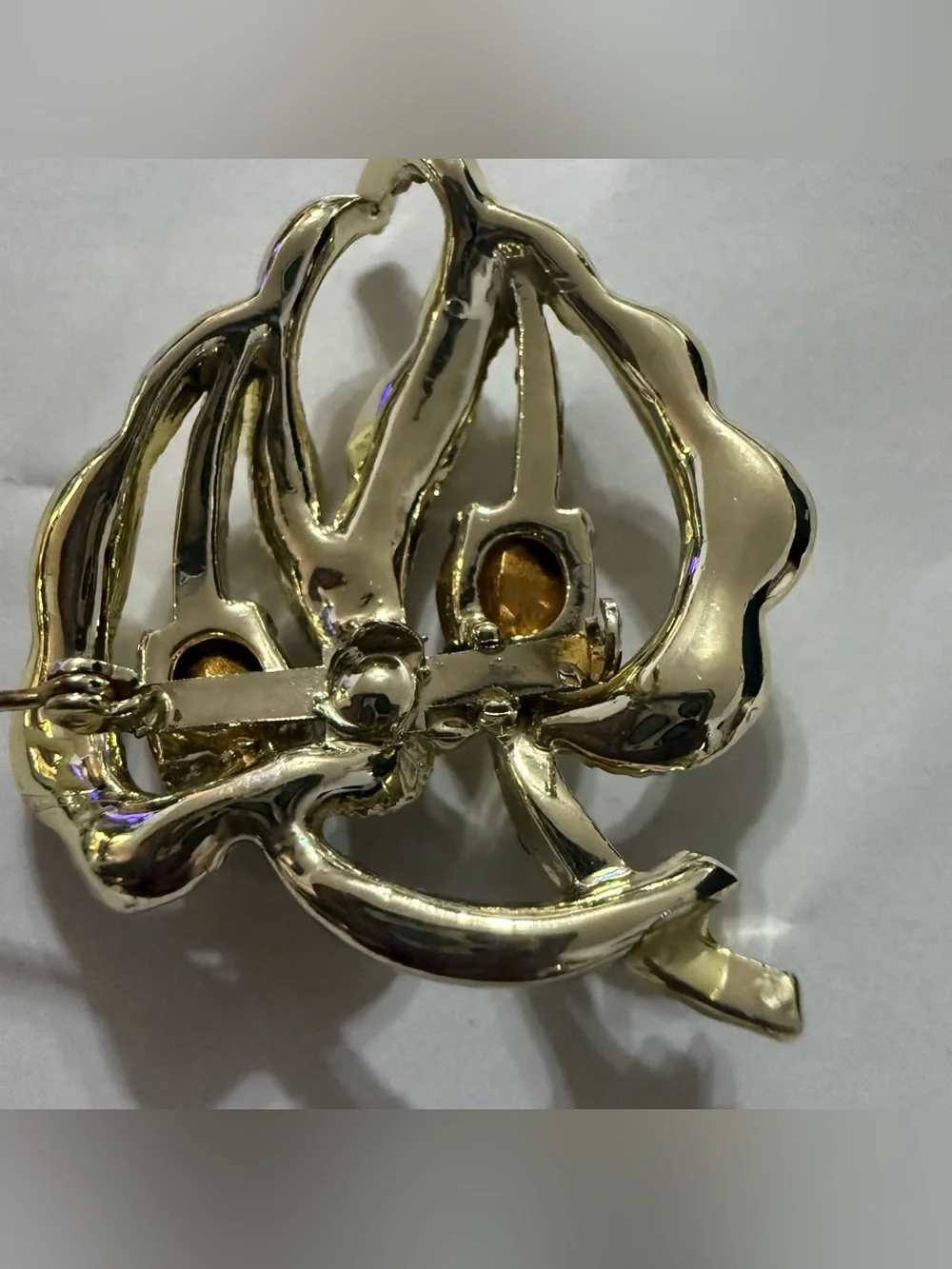 Vintage gold tone leaf brooch with red and clear rhinestones